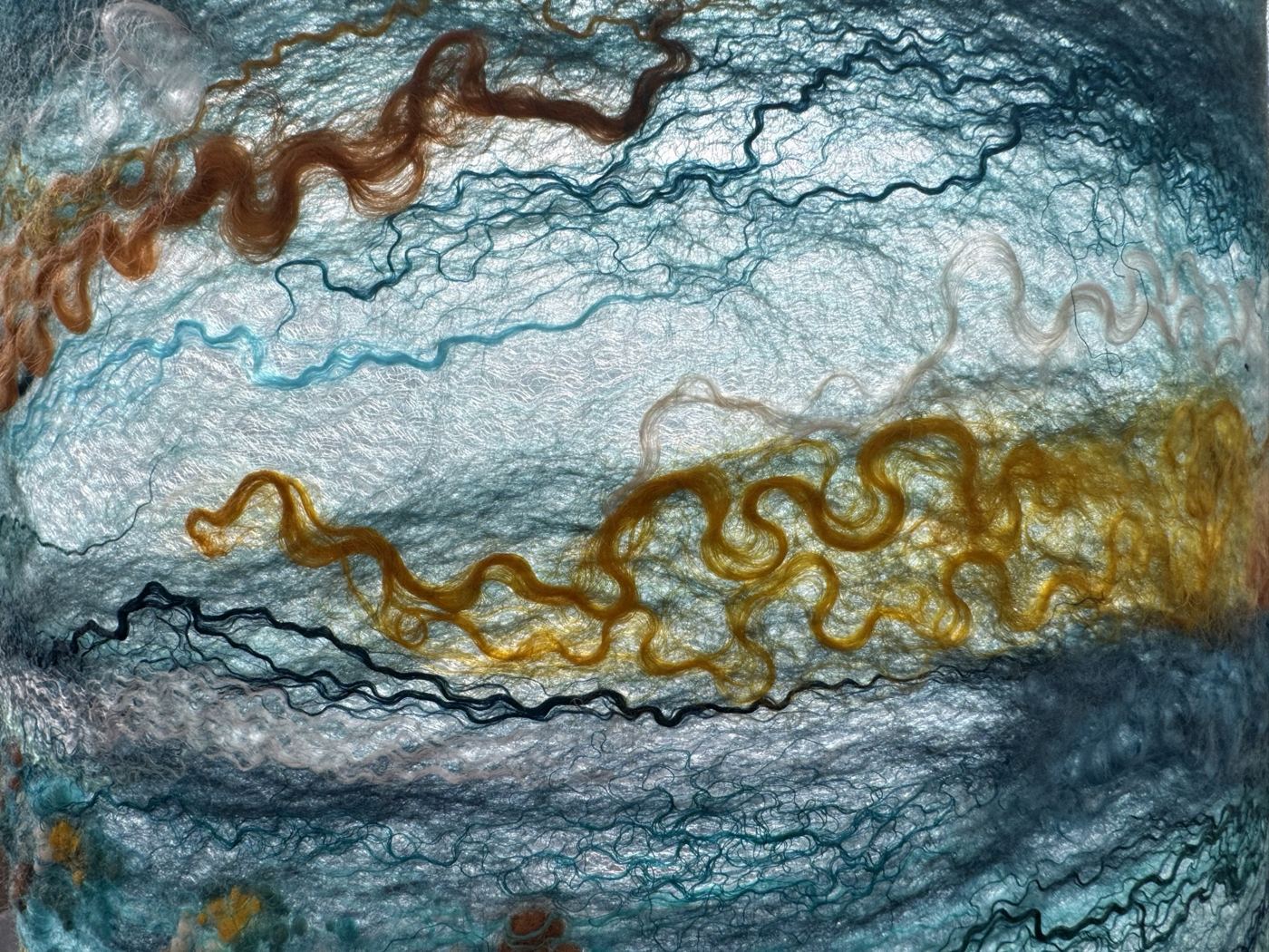 Gold wool locks and teal silk felted together