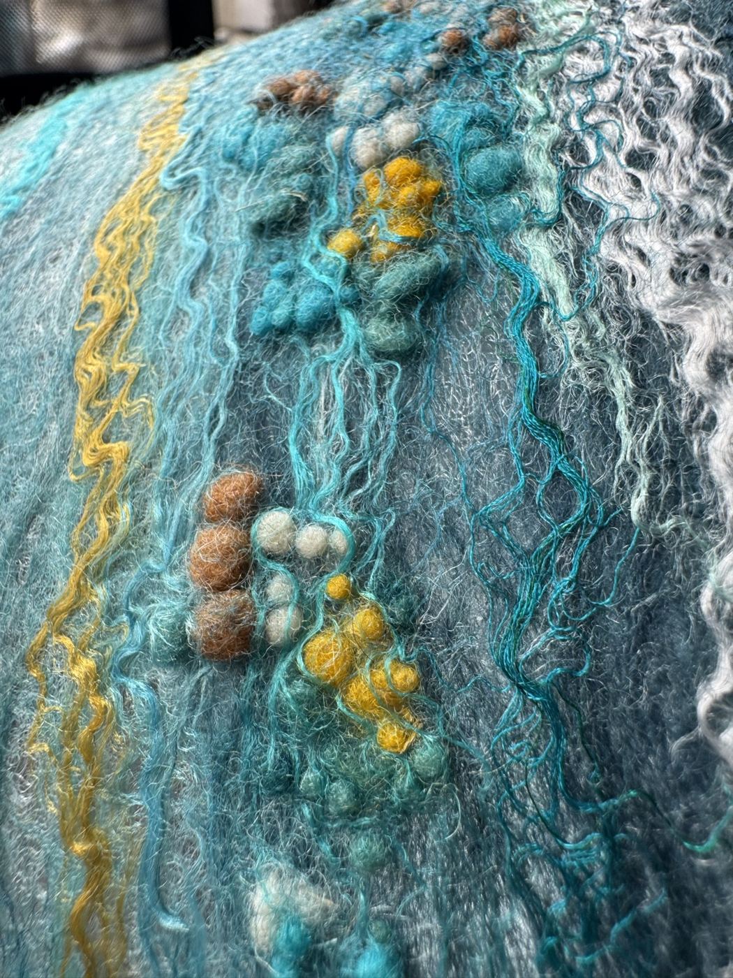 Detail of wool locks and neps on felted silk