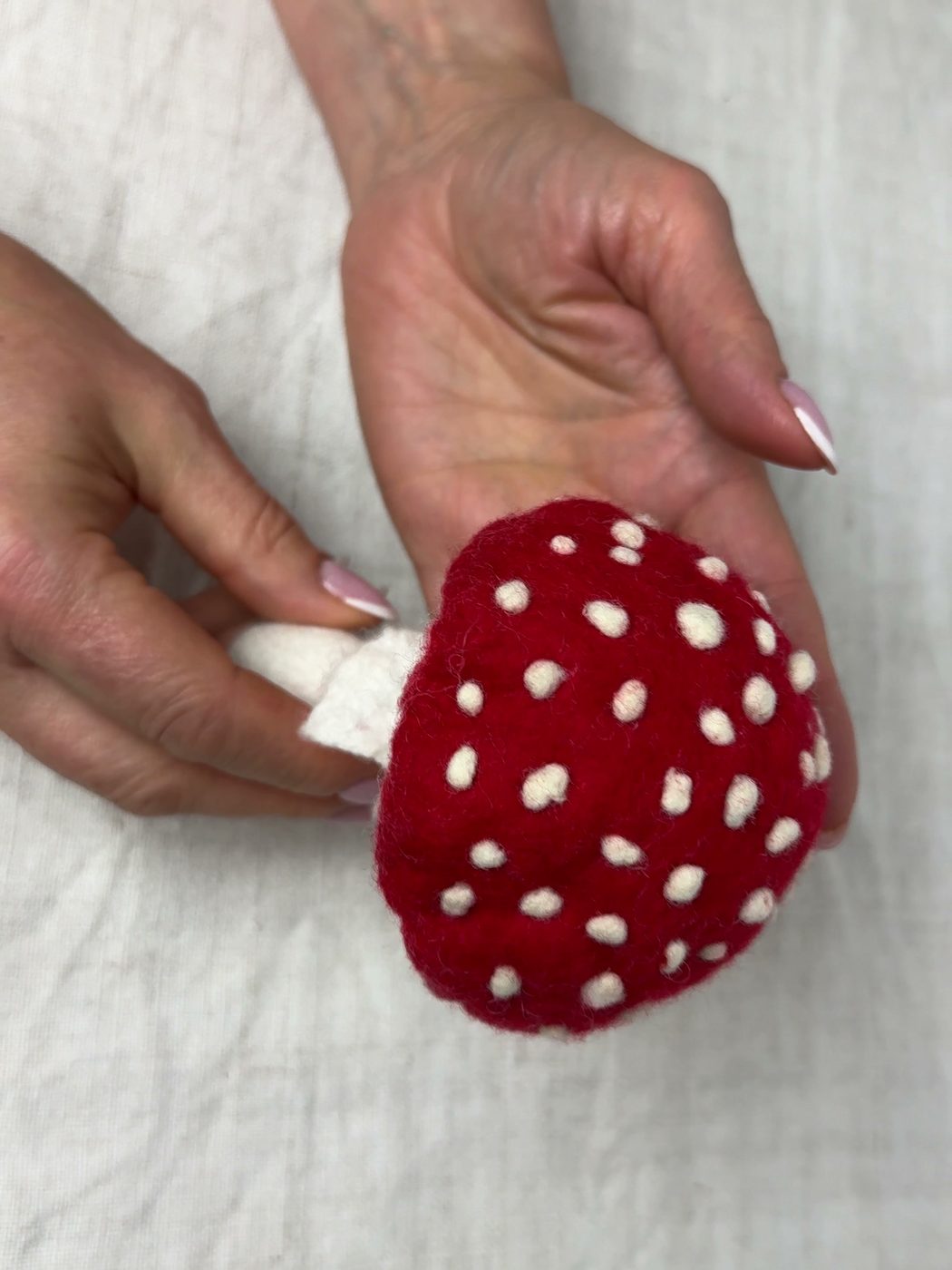 Svetlana holding a red felted fly agaric with white spots
