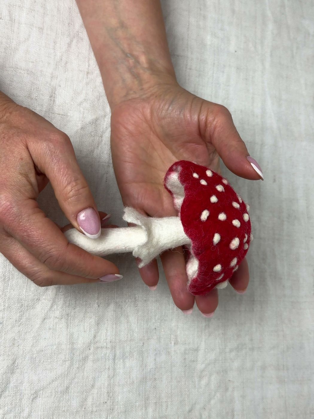 Felted fly agaric held in the hand